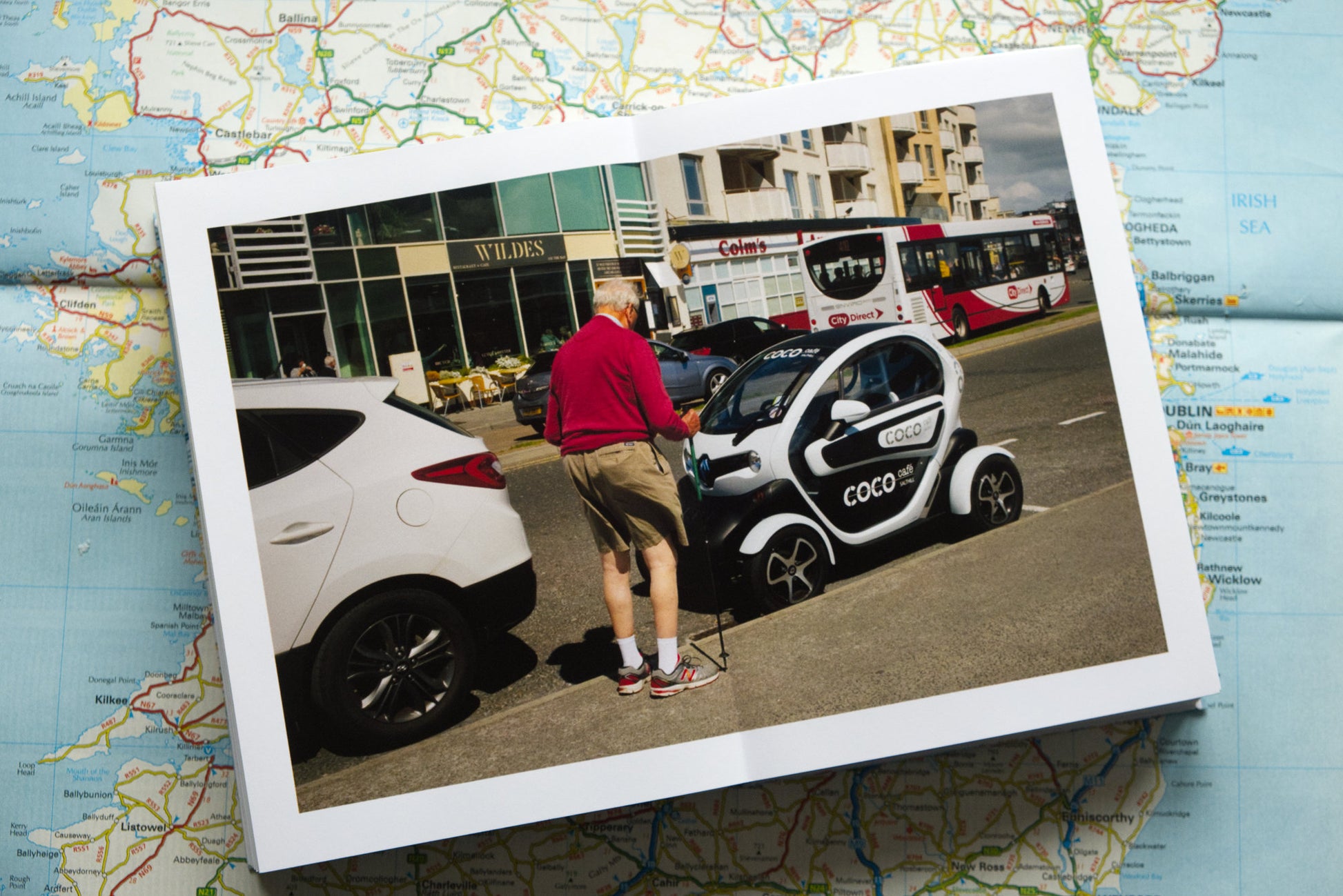 product photograph of handmade photography book showing an interior double page spread of street scene from Galway City.